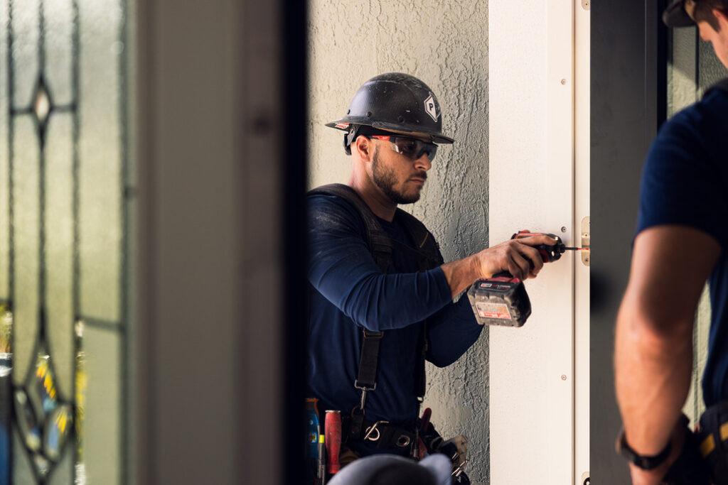 Installer working on door replacement