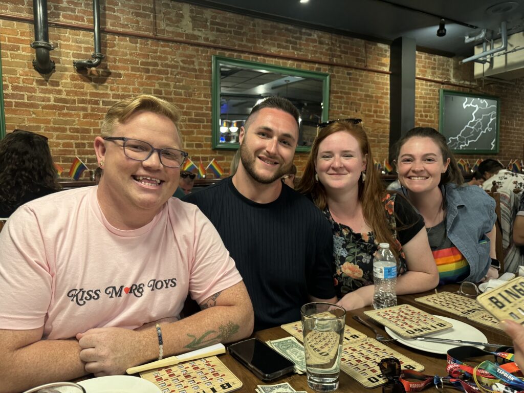 employees pose for photo at dinner