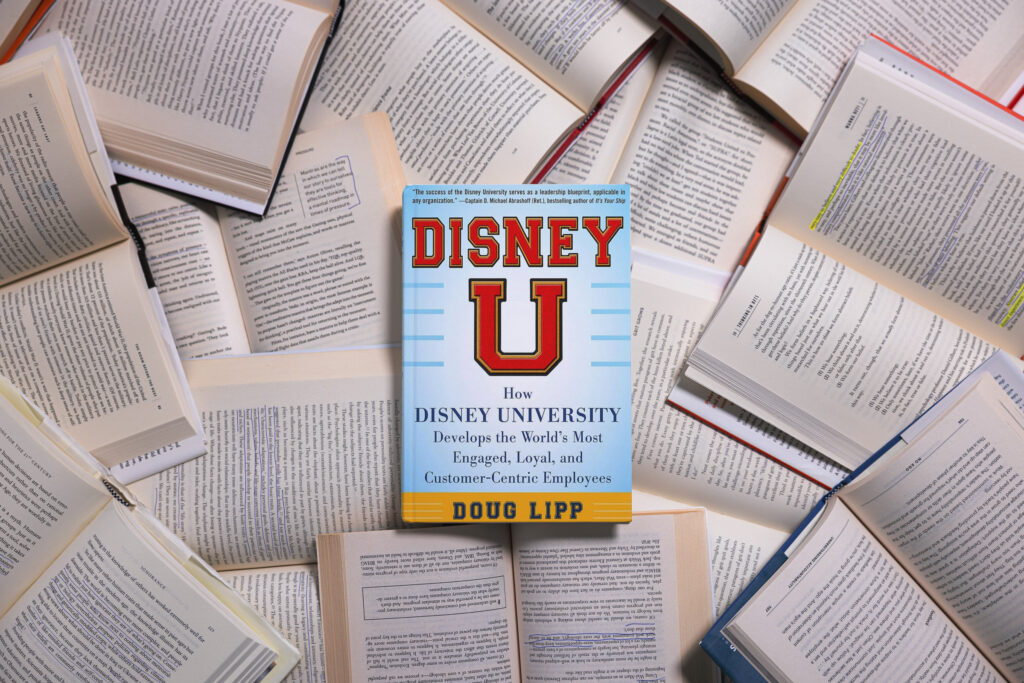 Disney U book photographed amid backdrop of open books.