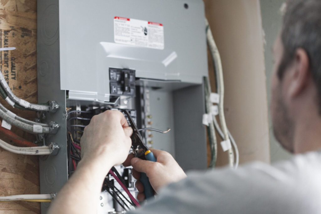 Homeowner working on an electrical panel.