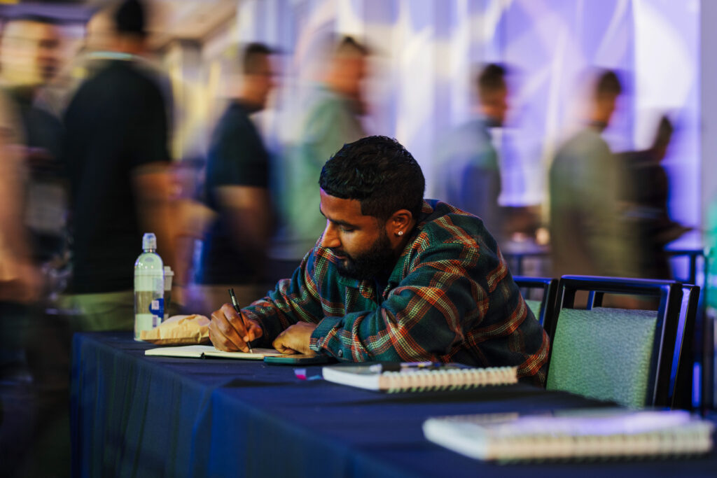 A Leadership conference attendee taking notes following a content session.