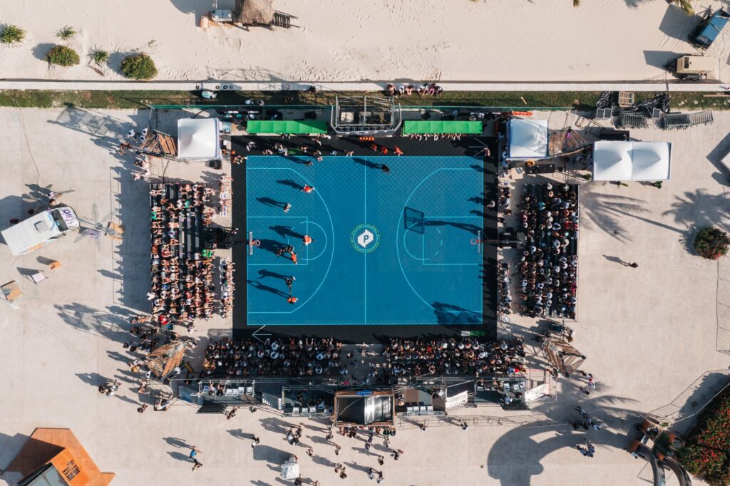 An aerial shot shows the Quest Basketball court on the beach.