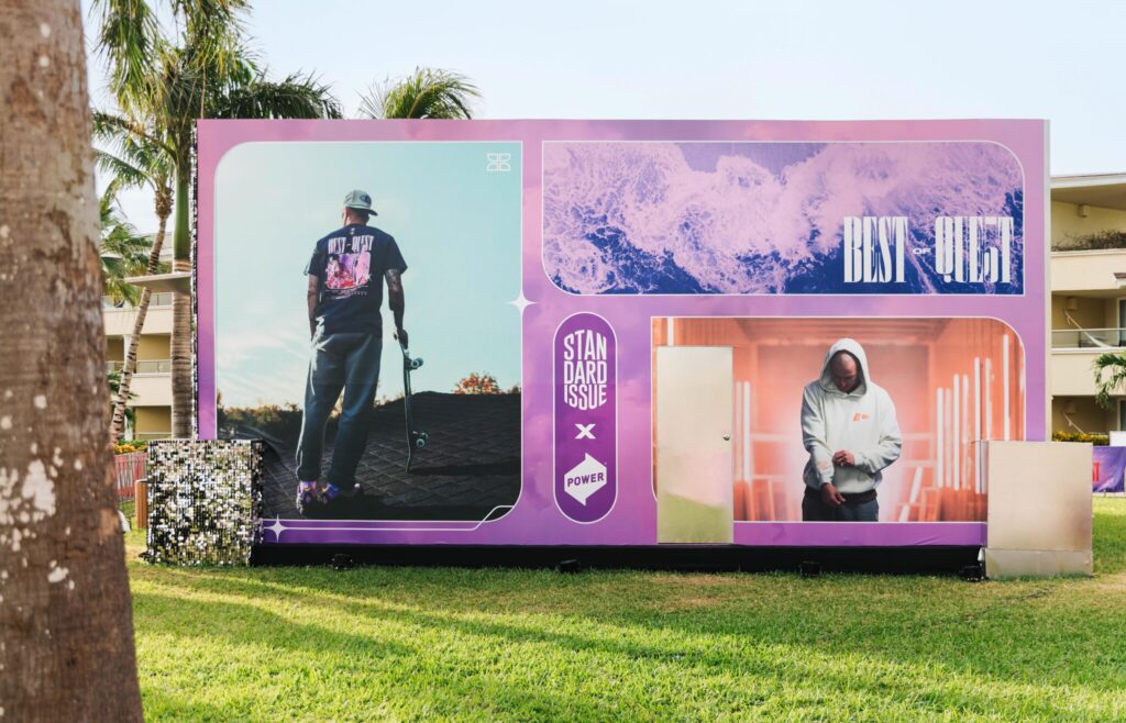 A photo of the side of the Quest merch booth, which sported photos of the POWER x Standard Issue collab.