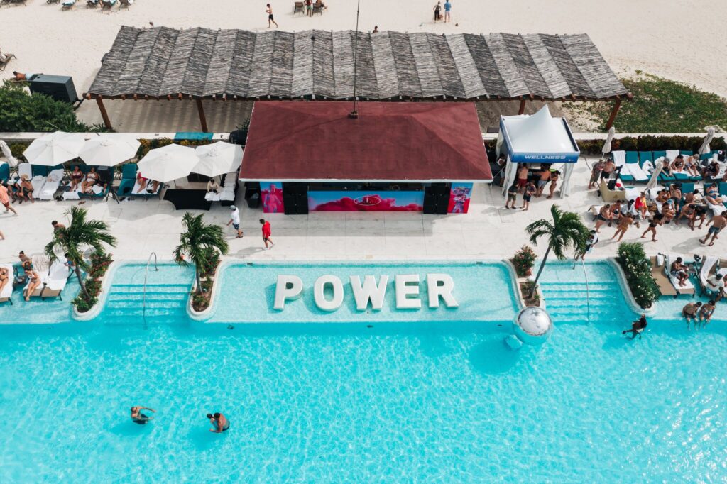 An aerial view of the pool in Mexico during Quest with the word "POWER" displayed in the water.