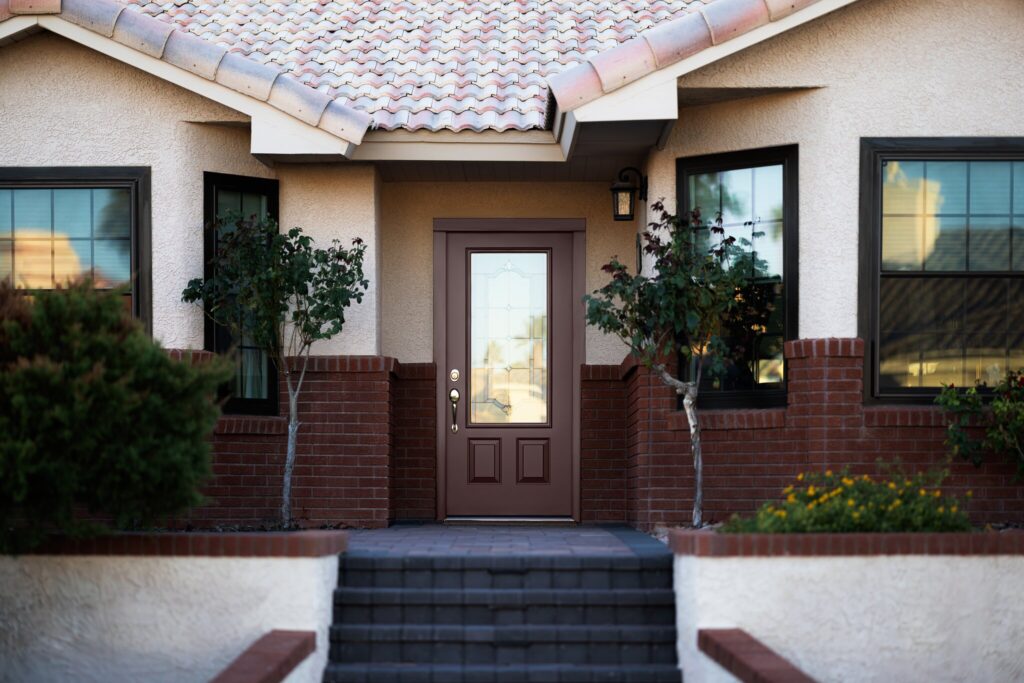A POWER door flanked by two trees.