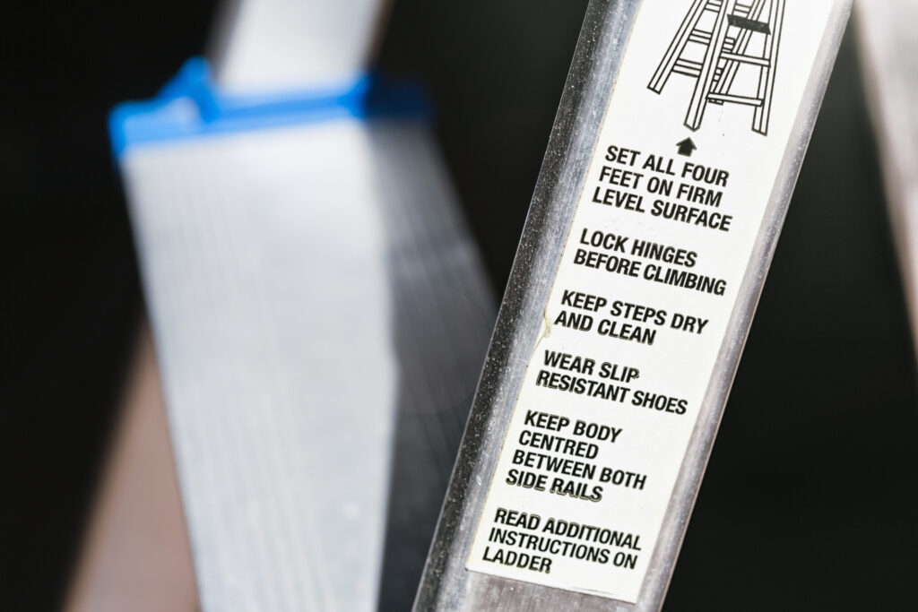 Close up of ladder label stating safety instructions.