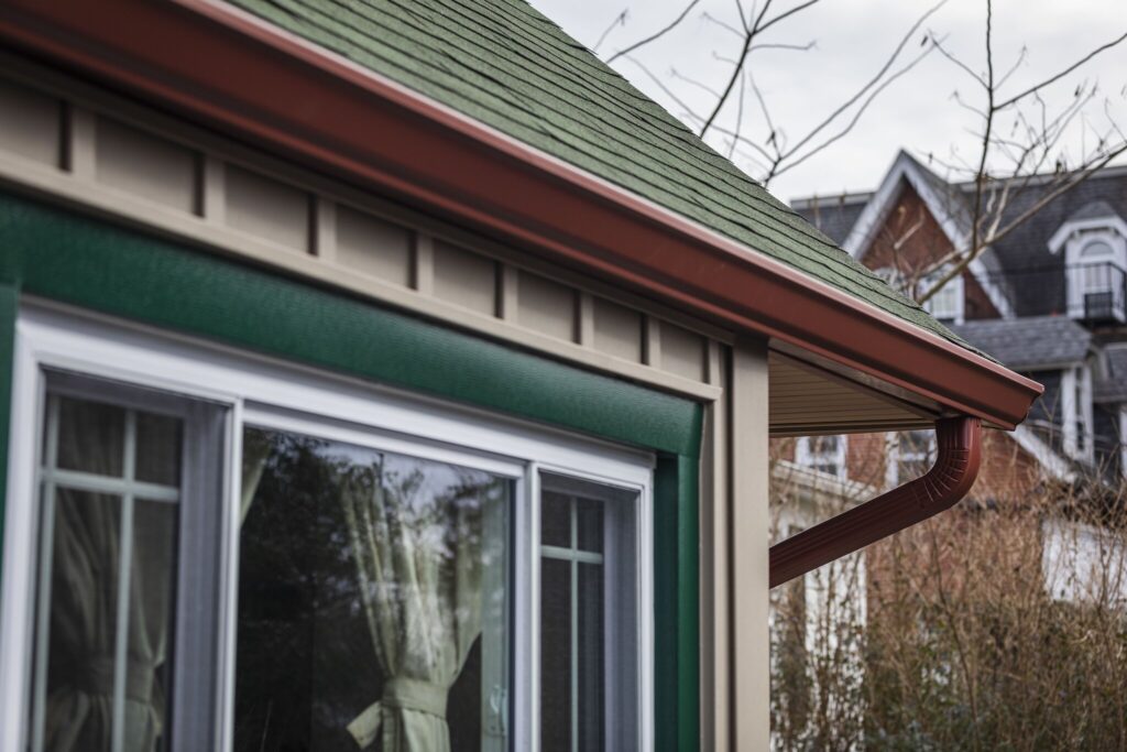 A POWER house with red gutters and green trim.