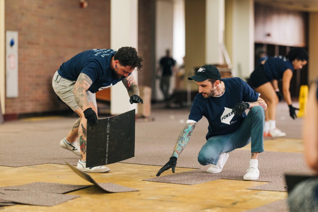 POWER employees volunteer to help lay new carpet for the Chester High School library. 