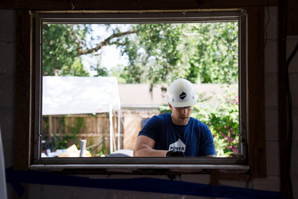 Employee installs a window on a Tampa home.